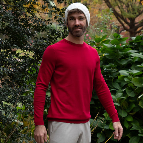 Man standing in front of bushes