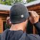 Man sporting a Unisex Brooklyn Beanie in dark gray (basalt)