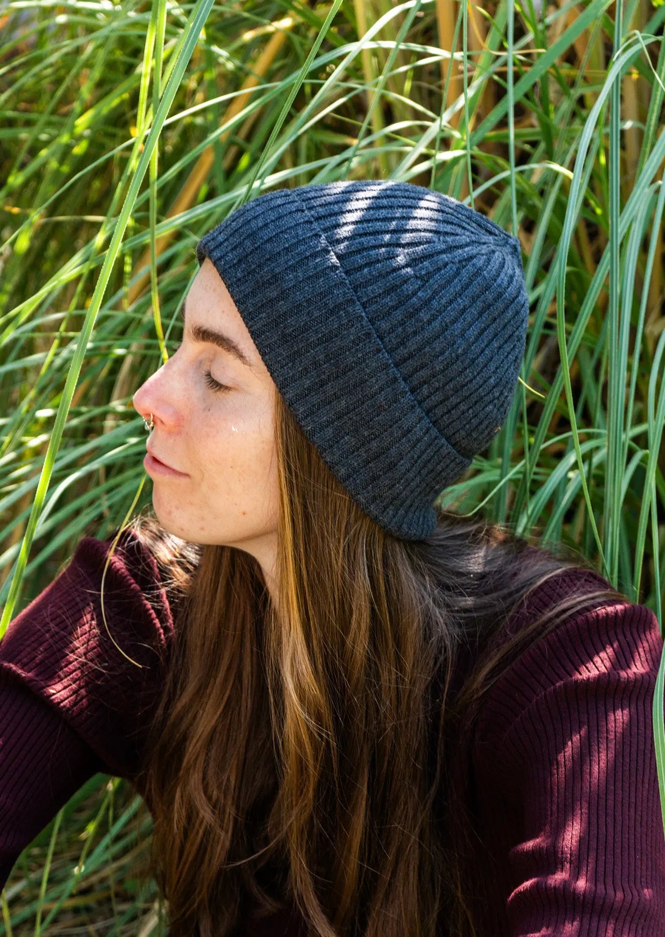 Woman outdoors wearing a Unisex Brooklyn Beaniein dark gray (basalt)